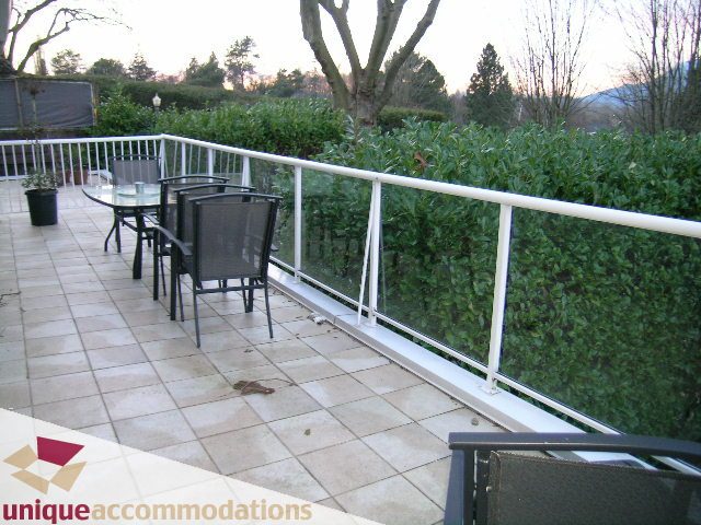 Furnished patio with outdoor seating and greenery. - 3967 West Broadway, Vancouver West Side