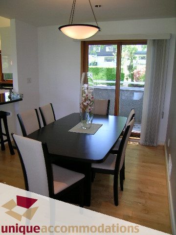 Spacious dining area with hardwood floors and city view. - 3967 West Broadway, Vancouver West Side