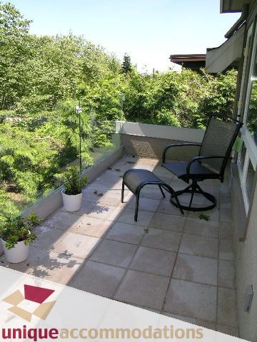 Furnished patio with outdoor seating and greenery. - 3967 West Broadway, Vancouver West Side