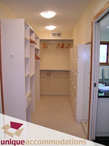 Furnished walk-in closet with hanging rods and shelves. - 3967 West Broadway, Vancouver West Side
