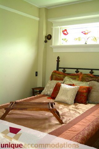 Cozy bedroom with patterned bedspread and decorative pillows. - 1 - 2812 Yukon, Vancouver West Side