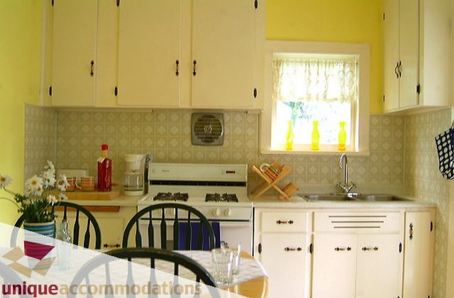 Bright kitchen with yellow walls, white cabinets, and patterned backsplash. - 1 - 2812 Yukon, Vancouver West Side