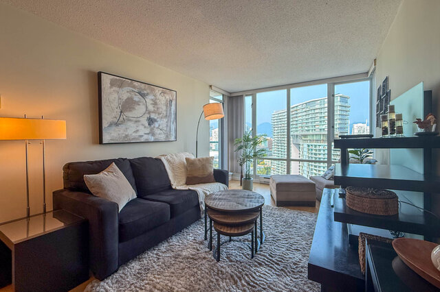 Spacious living room with a city view, modern furnishings, and a cozy ambiance. - 2602 - 1033 Marinaside Crescent, Vancouver Downtown