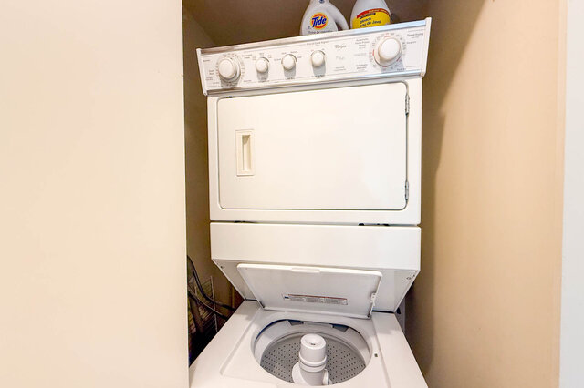 Compact laundry area with stacked washer and dryer, tidy and functional. - 2602 - 1033 Marinaside Crescent, Vancouver Downtown