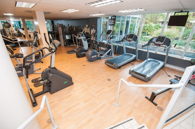 Spacious, well-lit gym with hardwood floors, treadmills, and large windows offering a city view. - 2602 - 1033 Marinaside Crescent, Vancouver Downtown