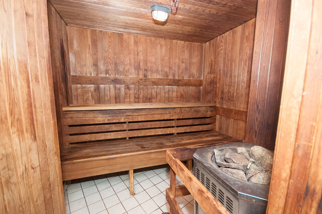 Cozy wooden sauna with tiled floor and rock heater. - 2602 - 1033 Marinaside Crescent, Vancouver Downtown
