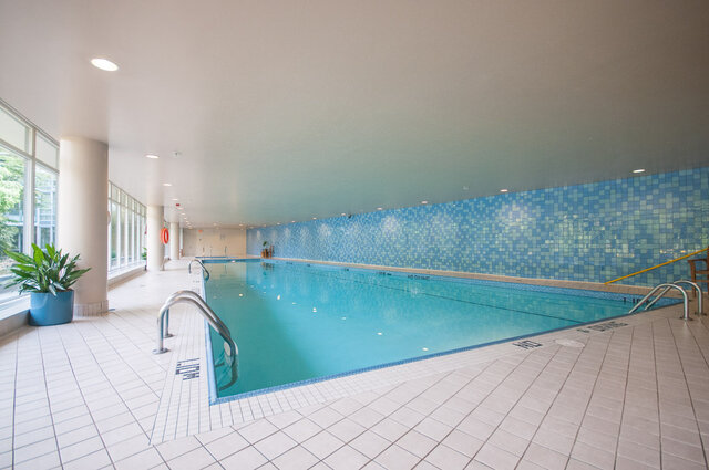 Spacious, modern indoor pool with blue mosaic tiles and ample natural light. - 2602 - 1033 Marinaside Crescent, Vancouver Downtown