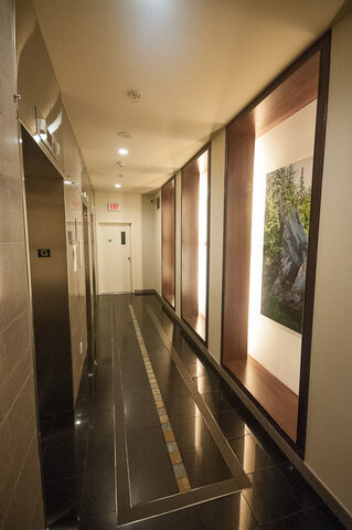 Spacious hallway with modern decor and framed artwork, leading to a well-lit entrance. - 2602 - 1033 Marinaside Crescent, Vancouver Downtown