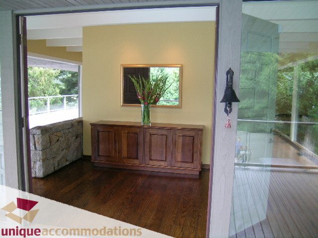 Furnished living room with hardwood floors and a large window view. - 6189 Nelson Avenue, West Vancouver