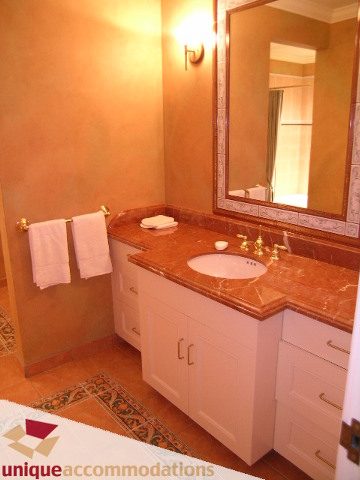 Furnished bathroom with marble countertops and a gold towel bar. - 6189 Nelson Avenue, West Vancouver