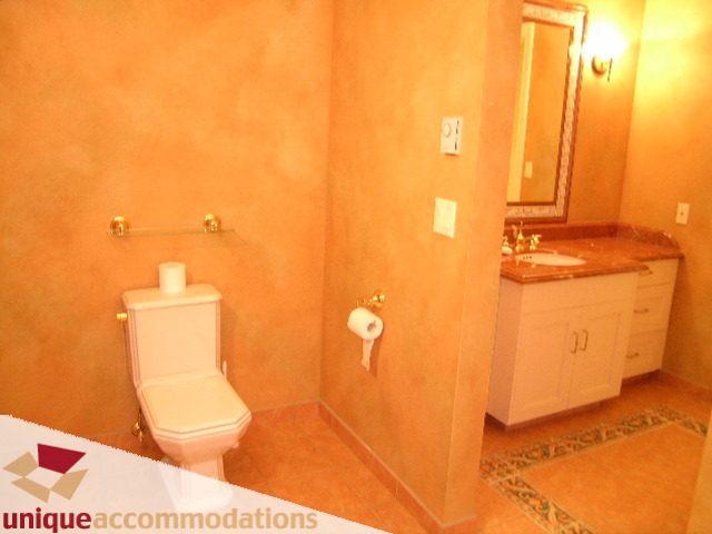 Bathroom with marble countertops and gold accents. - 6189 Nelson Avenue, West Vancouver