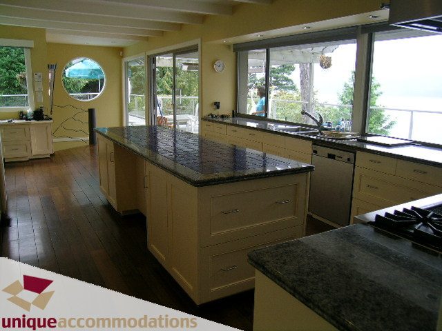 Bright kitchen with granite countertops, hardwood floors, and a city view. - 6189 Nelson Avenue, West Vancouver