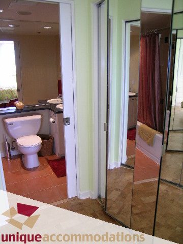Spacious bathroom with modern sink, toilet, and large mirror reflecting the cozy ambiance. - 1302 - 819 Hamilton Street, Vancouver Downtown