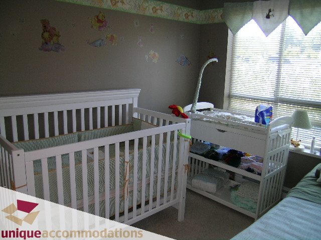 Bright nursery with white cribs and green bedding, large window with blinds. - 314 - 855 W. 16th Street, North Vancouver