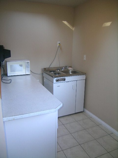 Bright kitchen with white countertops and a small sink, clean and minimalistic. - 1250 Seymour Blvd, North Vancouver