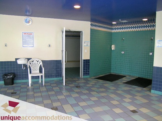 Spa area with tiled walls and floor, chairs, and a sink. - 3601-193 Aquarius Mews, Vancouver Downtown