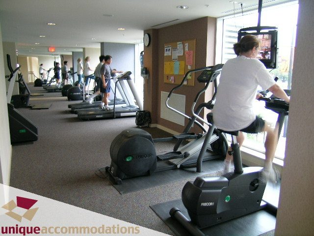 Fitness room with cardio equipment and large windows. - 3601-193 Aquarius Mews, Vancouver Downtown