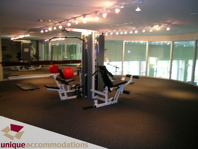 Bright gym with cardio equipment and large windows, offering a city view. - 3601-193 Aquarius Mews, Vancouver Downtown