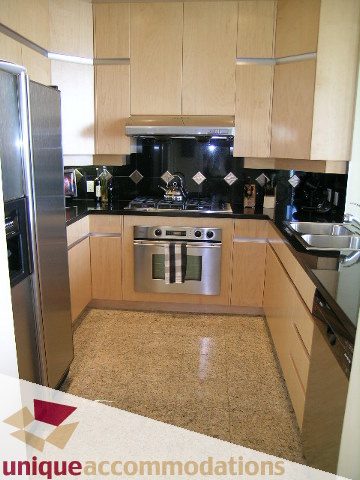 Bright kitchen with granite countertops and stainless steel appliances, modern design. - 3601-193 Aquarius Mews, Vancouver Downtown