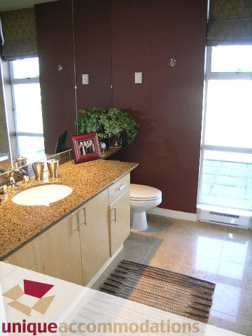 Furnished bathroom with granite countertops and large windows. - 3601-193 Aquarius Mews, Vancouver Downtown