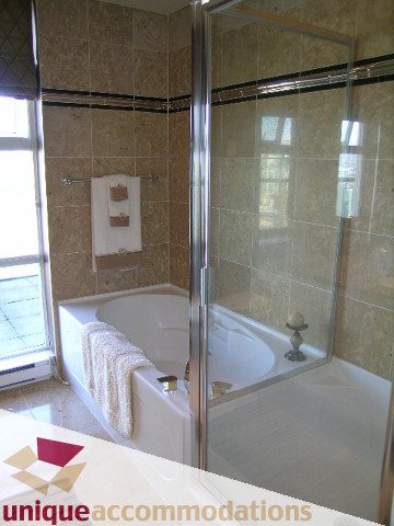 Spacious bathroom with marble countertops and a large walk-in shower. - 3601-193 Aquarius Mews, Vancouver Downtown
