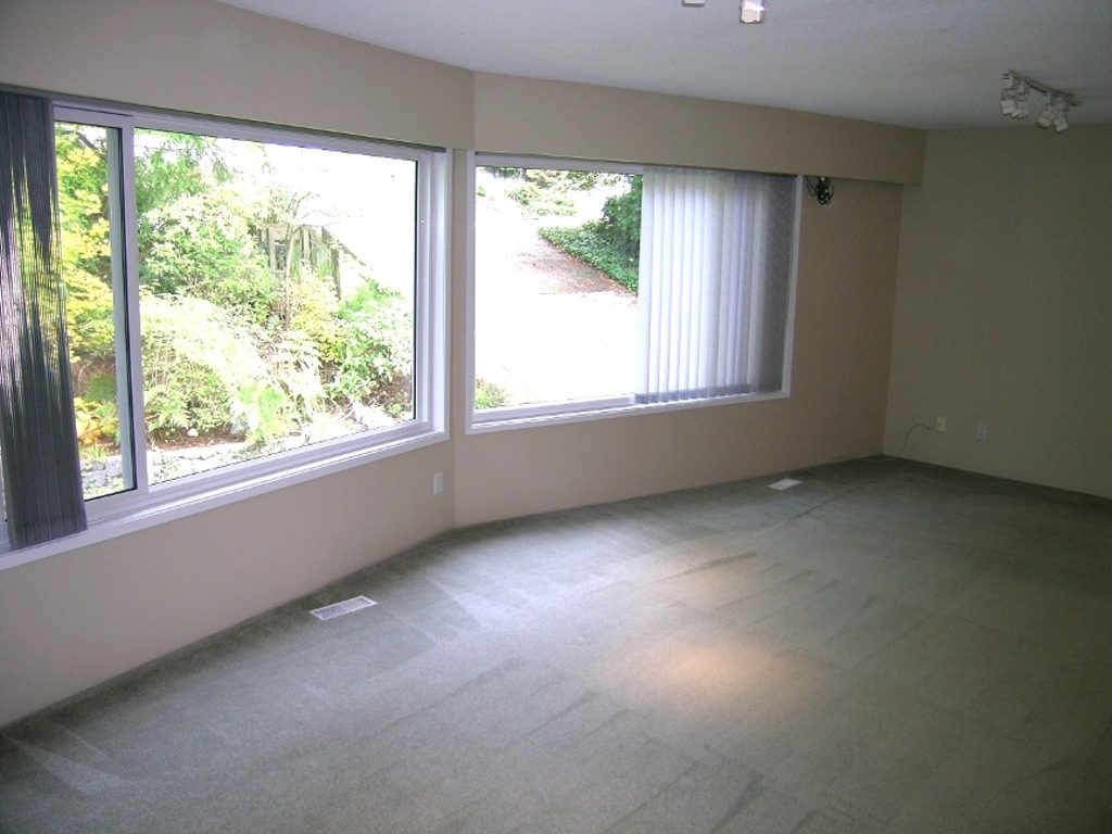 Spacious living room with large windows and a serene outdoor view. - 2331 Hyannis Drive, North Vancouver