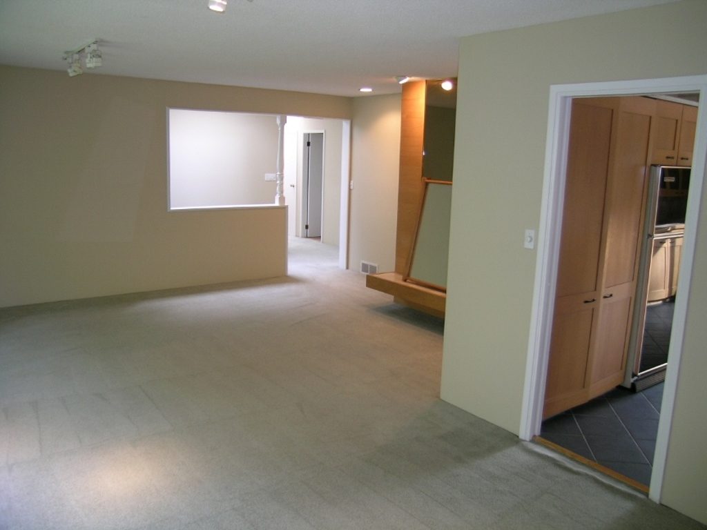 Spacious living room with hardwood floors and a cozy corner window. - 2331 Hyannis Drive, North Vancouver