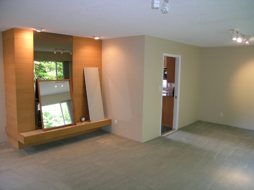 Spacious living room with modern design, featuring a unique corner wall and recessed lighting. - 2331 Hyannis Drive, North Vancouver