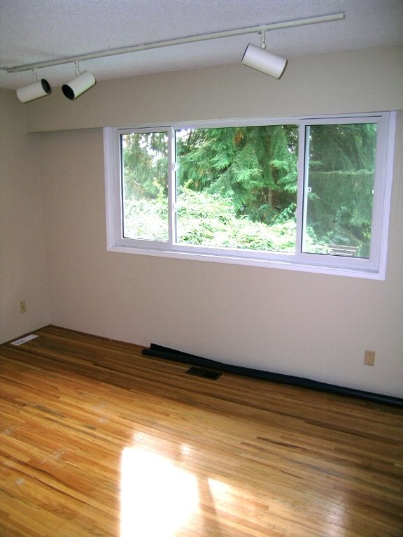 Spacious den with hardwood floors and a large window overlooking greenery. - 2331 Hyannis Drive, North Vancouver