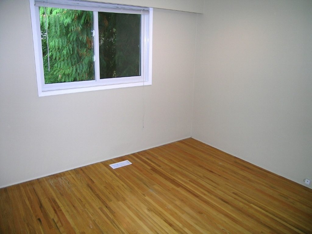 Spacious den with hardwood floors and a view of lush greenery outside. - 2331 Hyannis Drive, North Vancouver