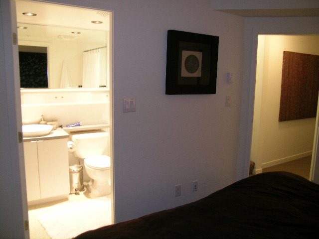 Bedroom with a view of the bathroom and a framed artwork on the wall. - 930 Beatty Street, Vancouver Downtown