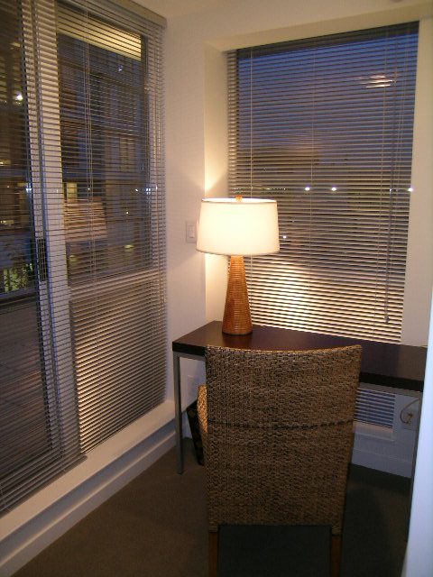 Bright living room with blinds, cozy seating, and a lamp. - 930 Beatty Street, Vancouver Downtown