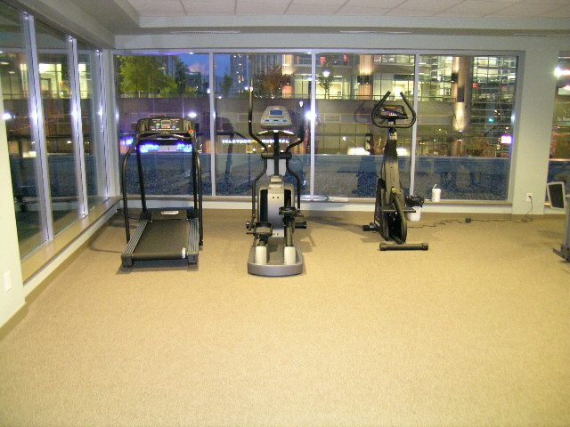 Bright fitness room with city view and cardio equipment. - 930 Beatty Street, Vancouver Downtown