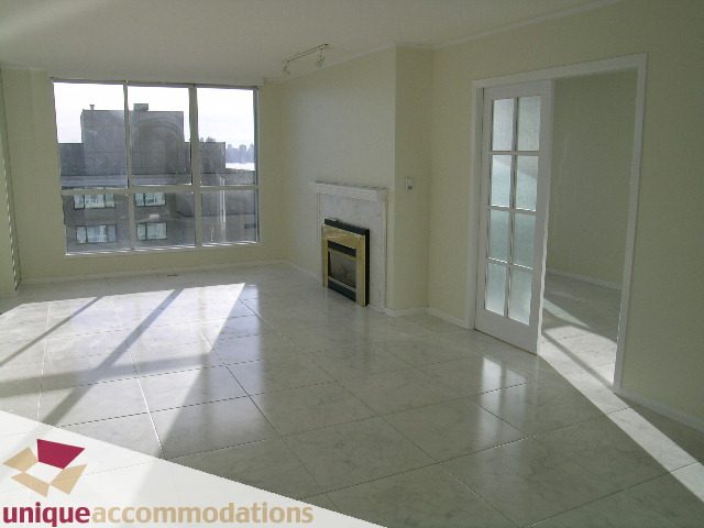 Spacious living room with large windows, marble floors, and fireplace. - PH1 - 125 West 2nd Street, North Vancouver