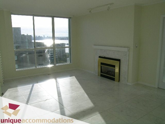 Bright living room with large windows, city view, and marble fireplace. - PH1 - 125 West 2nd Street, North Vancouver