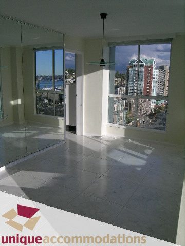 Bright living room with large windows and city view. - PH1 - 125 West 2nd Street, North Vancouver