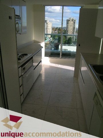 Bright kitchen with stainless steel countertops and a city view. - PH1 - 125 West 2nd Street, North Vancouver