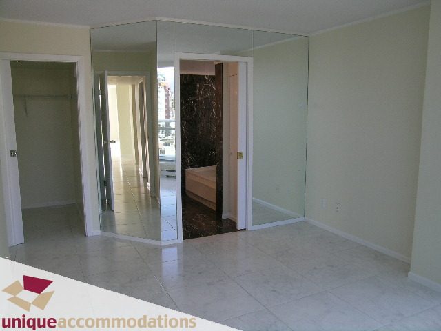 Bright living room with large mirrors and marble floors. - PH1 - 125 West 2nd Street, North Vancouver