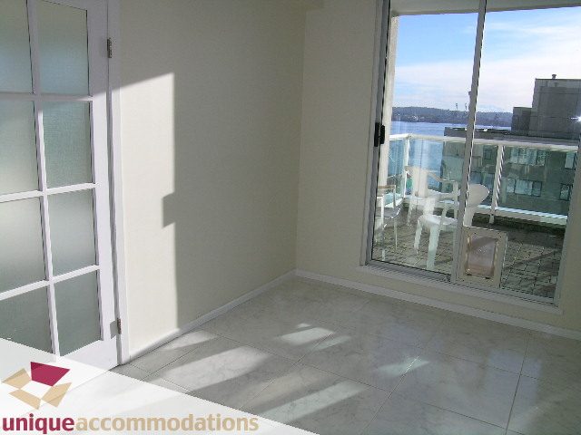 Bright living room with large windows, city view, and modern furniture. - PH1 - 125 West 2nd Street, North Vancouver