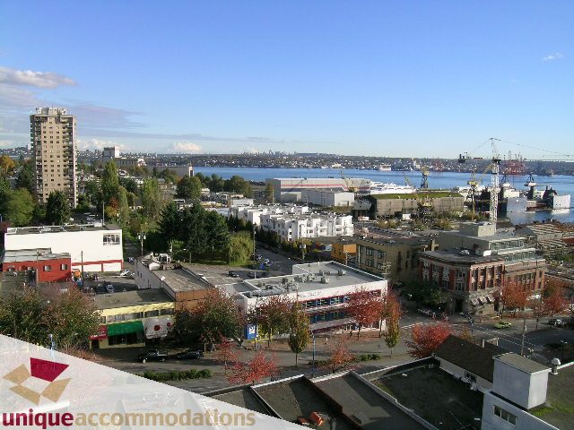 Furnished living room with city view and modern decor. - PH1 - 125 West 2nd Street, North Vancouver