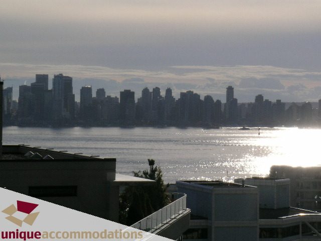 Bright living room with city view and balcony access. - PH1 - 125 West 2nd Street, North Vancouver