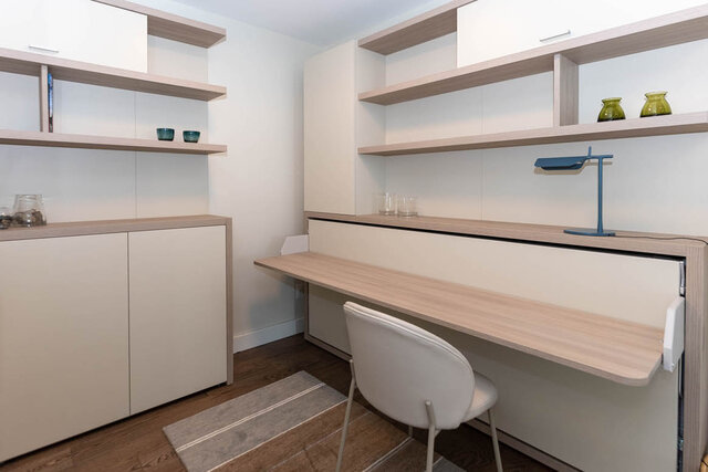 Furnished home office with light wood desk and white chair, shelves holding green vases. - 1703-1067 Marinaside Crescent, Vancouver Downtown