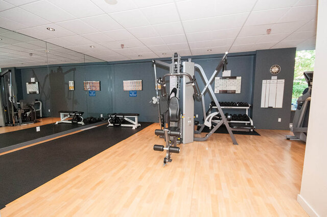 Fitness room with light wood flooring and mirrored walls. - 1703-1067 Marinaside Crescent, Vancouver Downtown