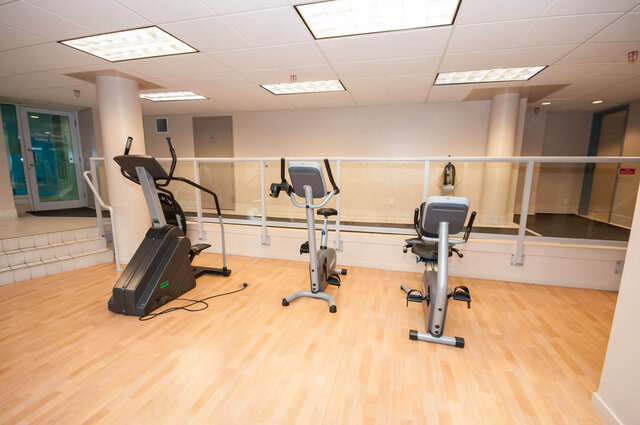Modern fitness room with hardwood floors and stationary bikes. - 1703-1067 Marinaside Crescent, Vancouver Downtown