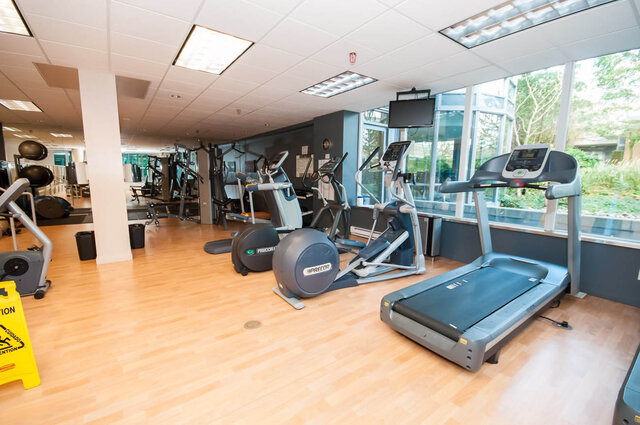 Gym with treadmill and elliptical machines, large windows overlooking greenery. - 1703-1067 Marinaside Crescent, Vancouver Downtown