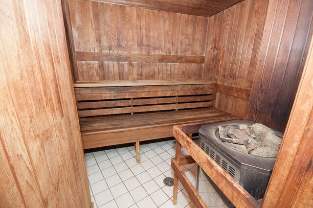 Wooden sauna with built-in benches and stone stove. - 1703-1067 Marinaside Crescent, Vancouver Downtown