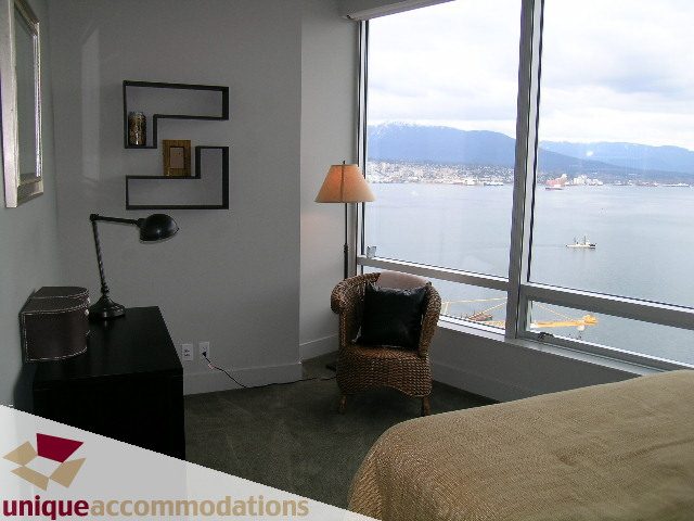 Furnished living room with a stunning city view, modern decor, and a cozy ambiance. - 2601 - 1077 West Cordova Street, Vancouver Downtown