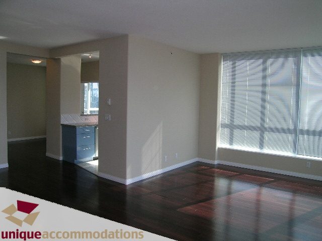 Bright living room with hardwood floors and large windows, showcasing a city view. - 3401 - 1328 W. Pender Street, Vancouver Downtown
