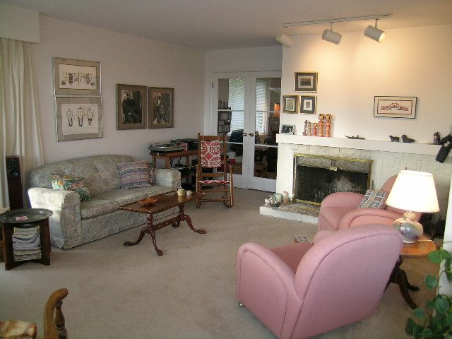 Cozy living room with vintage furniture, fireplace, and artwork, perfect for relaxation. - 1495 Kings Avenue, West Vancouver