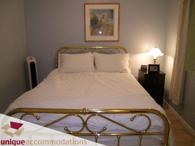 Furnished 1-bedroom condo with brass bed frame and white bedding. - 406 - 1688 Cypress Street, Vancouver West Side